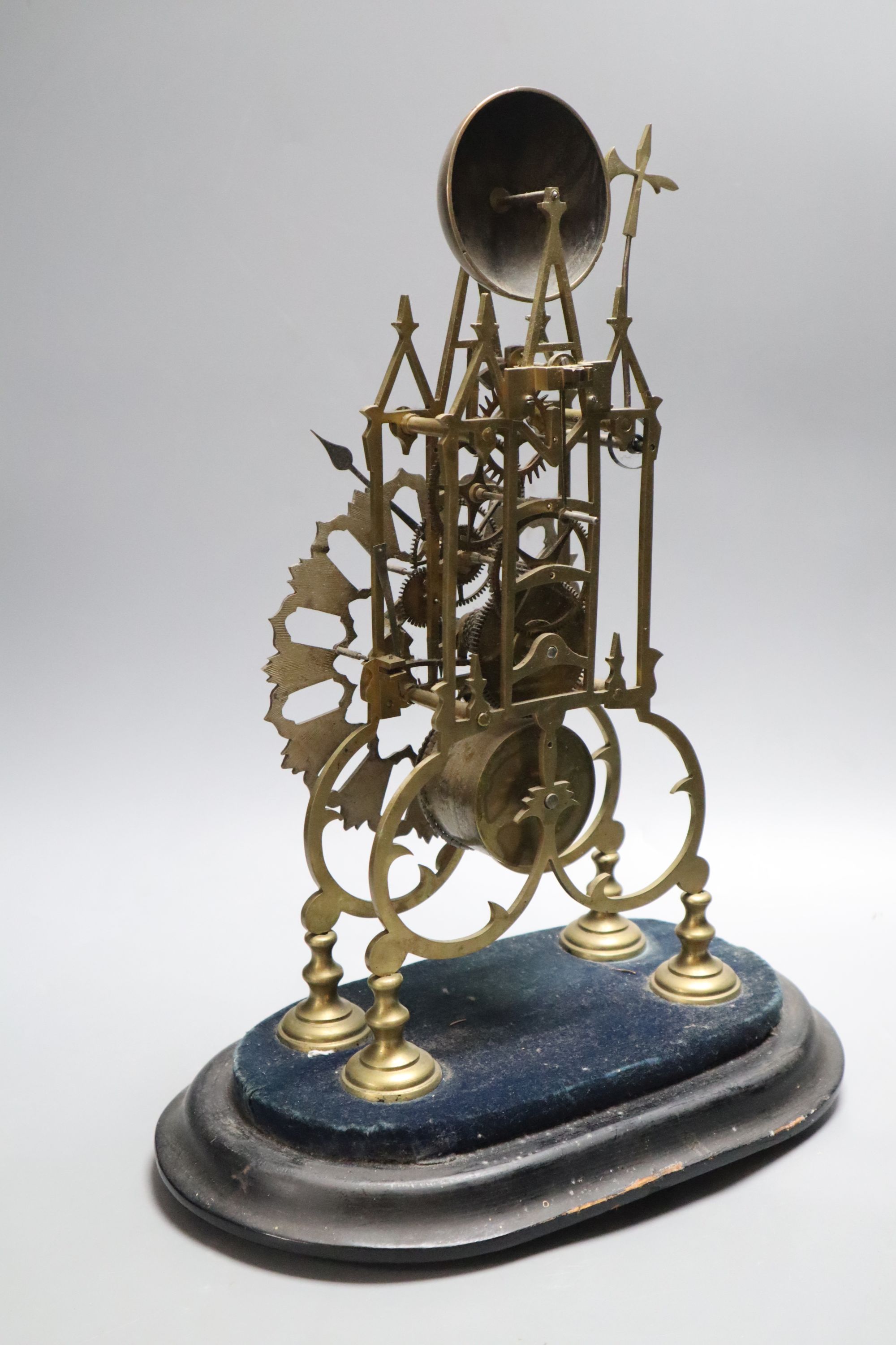 A Victorian brass skeleton clock, under dome